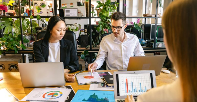 Team of business professionals collaborating in a modern office, representing different types of controlled transaction.